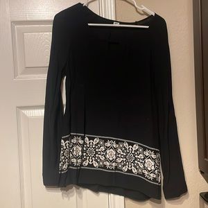 Long sleeve thin black shirt with white design around bottom. Size Small